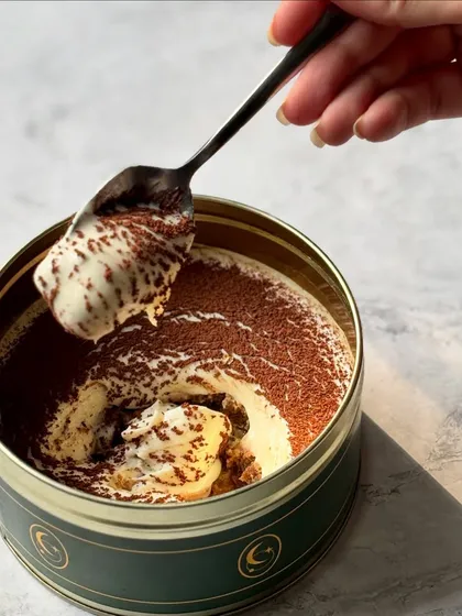 The creamy, cloud-like texture of our authentic Italian Tiramisu. Each spoonful is a perfect balance of coffee, cream, and cocoa.