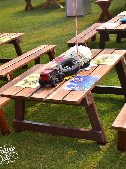 The picnic-style seating for the kids at the Transformers party. I used tires and miniature monster trucks as centrepieces to carry the mechanical, rugged theme through to the dining tables.