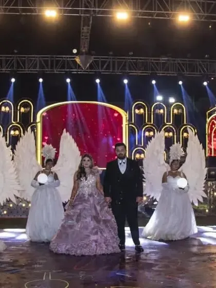The stage comes alive with a grand couple entry. Dancers with angel wings and orbs flank the couple, complemented by the warm lighting and cold pyro effects of the sangeet stage I designed.