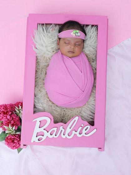 Our real-life Barbie doll, sleeping soundly in her pink box. This is one of our most popular and creative newborn setups, perfect for your little princess.