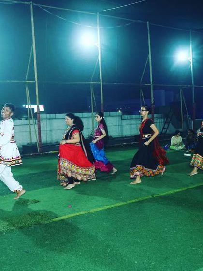 A candid shot of a Garba line dance in progress. The energy at these events is infectious, with everyone moving together to the beat.