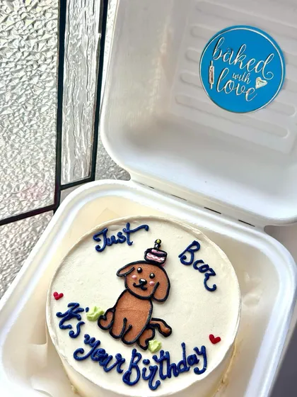 A cute dog-themed bento cake with a fun pun. This is a perfect example of our custom illustration work for pet lovers.