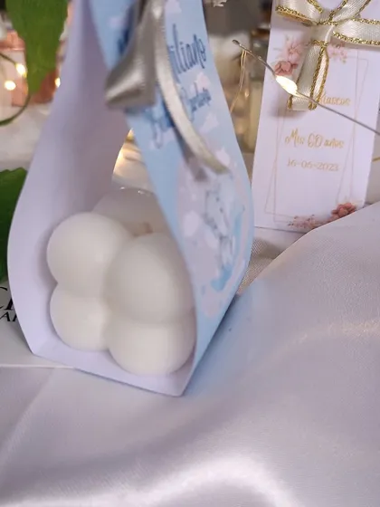 This shows our custom paper packaging for bubble candles, which can be designed to match any theme, like this one for a baptism.