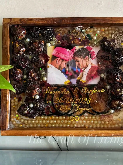 This stunning wooden frame preserves not only the varmala flowers but also the pearl strings and other decorative elements from the garland, creating a complete and authentic keepsake.
