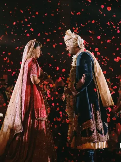 The final moment of the Varmala, surrounded by loved ones and a shower of petals. I stage these moments to feel both intimate and grand, creating a perfect portrait of joy.