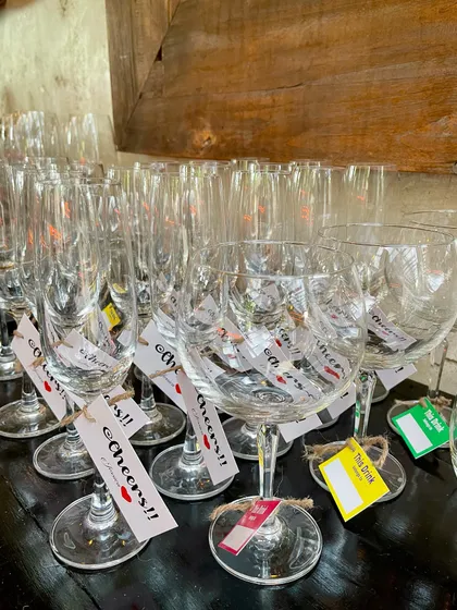 A set of wine glasses with custom tags, some with guest names and others with fun messages like "Cheers!!". It's a small detail that makes a big impact on the guest experience.
