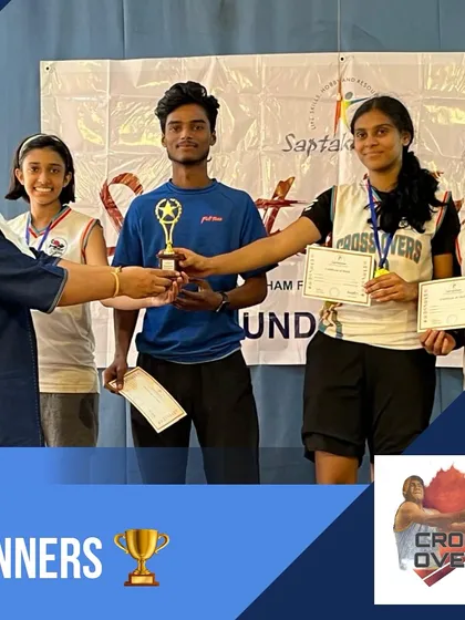 A coach and players from our girls' team receiving their winners' trophy. These moments of glory are built on a foundation of hard work.