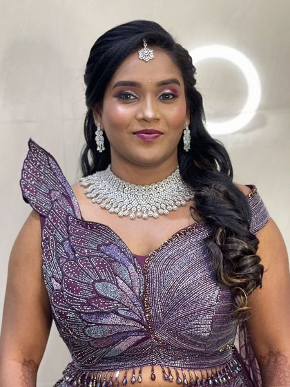 Anitha looking stunning in her one-of-a-kind reception outfit. The makeup is glamorous and modern, designed to match the drama of her dress.