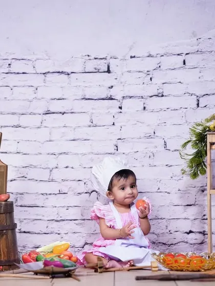 Caught in the act of tasting the fresh produce! These candid moments during a themed studio shoot make for the most memorable and authentic pictures.