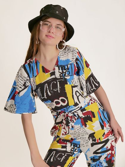 A three-quarter shot that shows the silhouette of the jumpsuit and its belted waist.