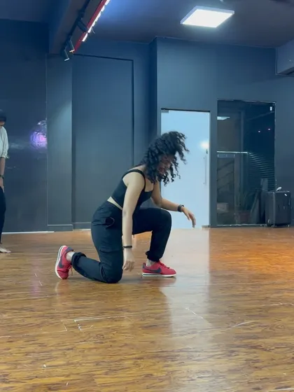 A dynamic floor-work pose from a dance routine. This shot captures the power and athleticism that goes into my choreography.