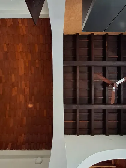A comparison of two different natural ceiling systems. On the left, a vault made with mud mortar, and on the right, a traditional wooden slab ceiling known as 'Mucchige'. Both offer unique textures and sustainable benefits.