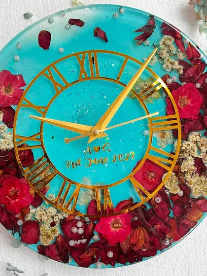 I love when clients choose bold colors. For this 12-inch wall clock, I used a vibrant turquoise resin to make the preserved red and white flowers pop. It’s a unique and personal piece of functional art.