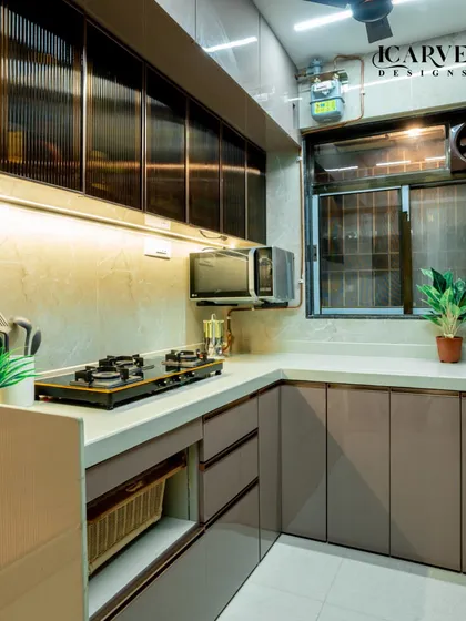 A detailed look at this modular kitchen, showing the pull-out wicker basket for vegetables and the sleek, handleless drawers.