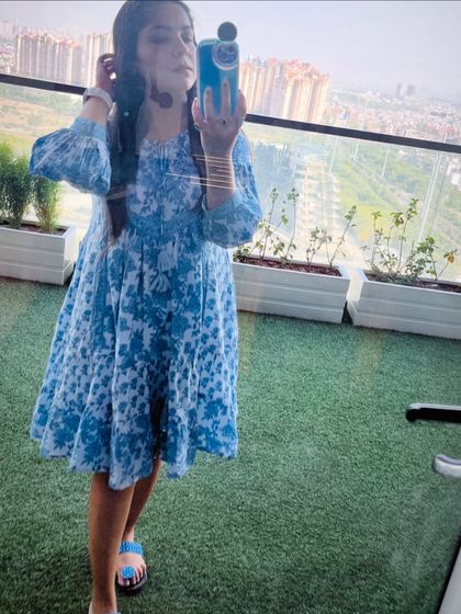 A selfie from my balcony in a blue and white printed dress. This is a perfect example of a comfortable and pretty dress for everyday wear at home.