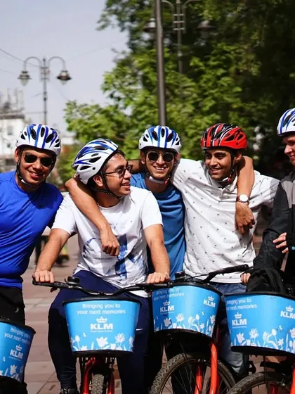 Friends who cycle together, stay together. A group of friends shares a laugh during a break on our Old Delhi tour.