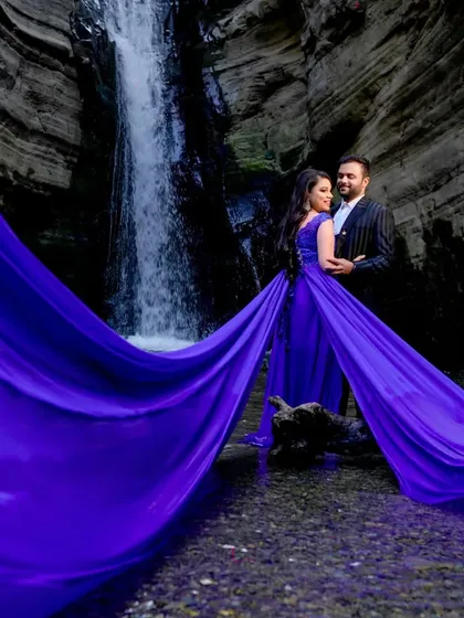 Our royal blue trail gown makes a splash in any nature setting. The rich color stands out beautifully against the natural tones of this waterfall location, and the flowing train adds a touch of magic and romance to your pre-wedding photos.