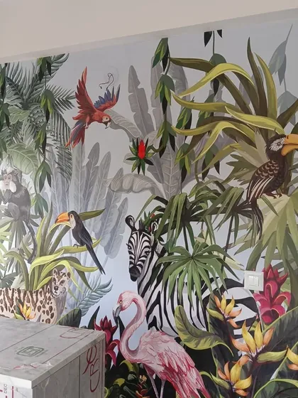 I love bringing the outdoors in with bold, tropical murals. This vibrant jungle scene, featuring a variety of animals and lush foliage, turned a plain wall into an exciting and colorful feature. It's a custom design perfect for making a statement in living rooms or creative spaces.