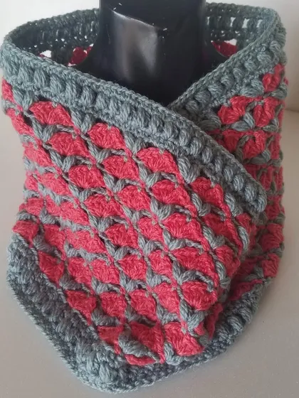 Here is the cowl in a different colorway of grey and pink, displayed on a mannequin to show how it wears. It's a wonderfully warm accessory for chilly days.