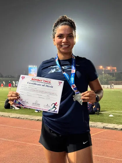 A proud moment for athlete Sharon, showcasing her silver medal and certificate from the Bombay YMCA athletic meet.