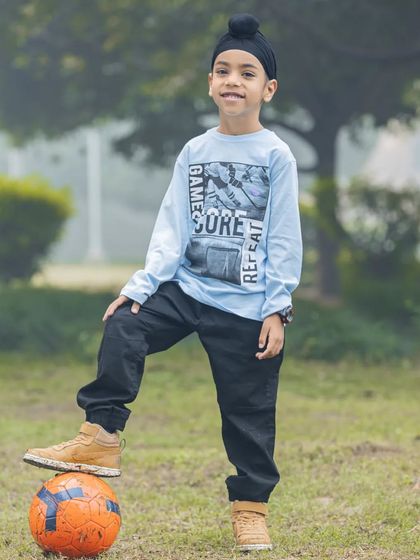 This young football star is ready for his game. Outdoor shoots are great for incorporating your child's hobbies and interests.