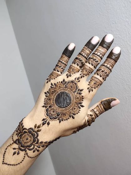 A beautiful mandala design with a floral border and delicate leafy vines extending from it.