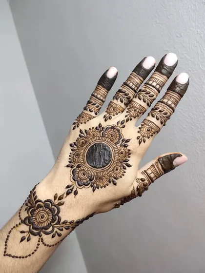 A beautiful mandala design with a floral border and delicate leafy vines extending from it.