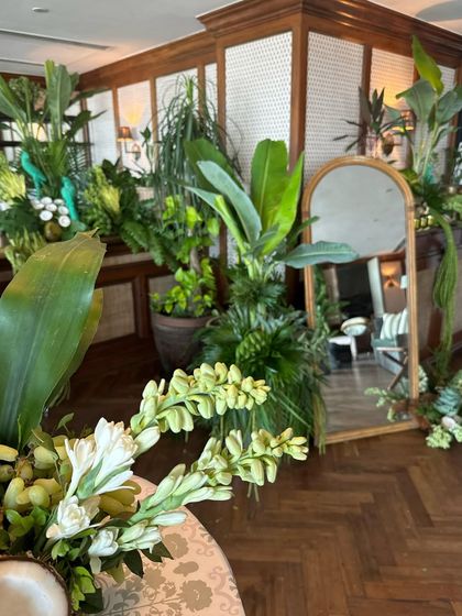 Another view of the tropical installation, creating a green oasis inside the venue.