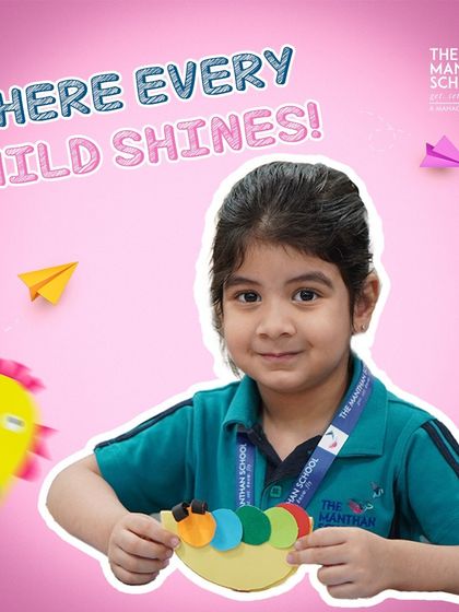 Where every child shines! A happy student shows off her colorful paper craft, a perfect example of the creativity we nurture.