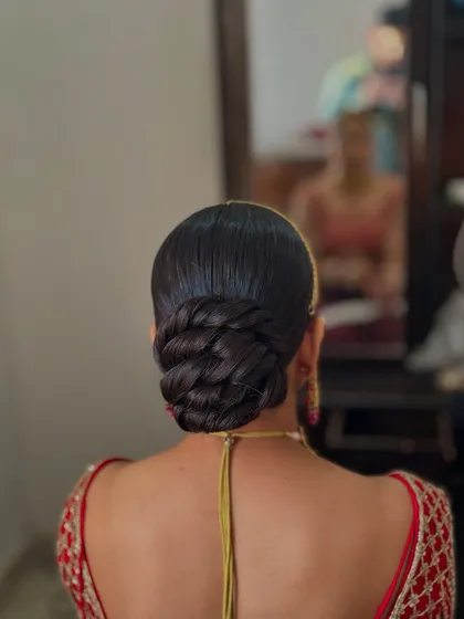 Another view of the clean twisted bun, highlighting its glossy finish and the precision of the twists.