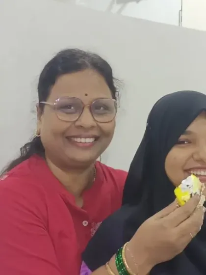 A teacher shares a piece of cake with a student during our Teacher's Day celebration, a sweet moment of bonding.