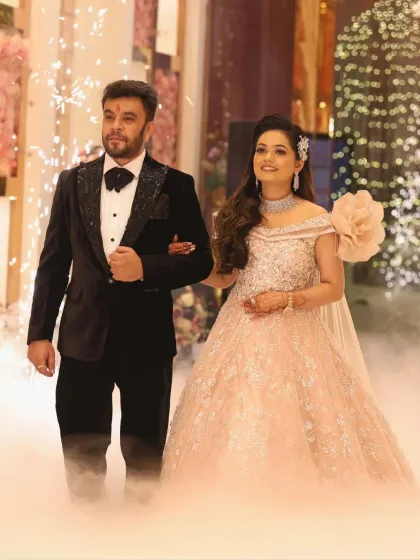 The couple makes their grand entrance through smoke. The bride's makeup is designed to be flawless and photo-ready for every moment.