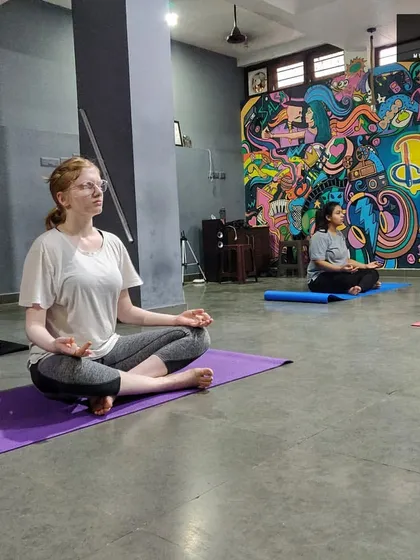 A moment of shared stillness during a guided meditation. Our classes include people from all walks of life, creating a diverse and welcoming community where everyone can find their own sense of peace.