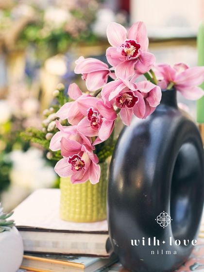 A close-up of a pink orchid, a favorite of the mom-to-be, incorporated into the baby shower decor.