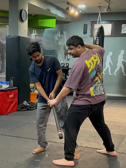 This is another variation of a stick defense, showing how to control the weapon from a different angle. The principles remain the same: close the distance, control the weapon, and neutralize the attacker.