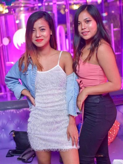 Two guests enjoying the stylish, purple-lit ambiance at one of my weekend gigs. I play at venues known for their great vibe and energetic crowds.