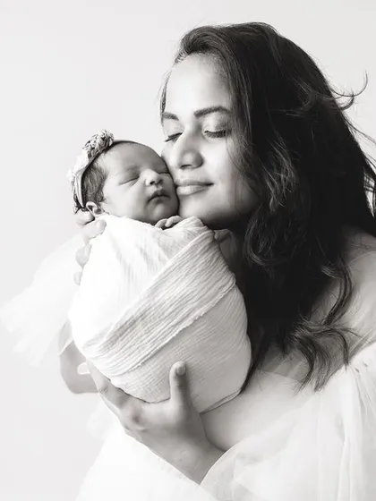 A mother's gentle kiss. This black and white photo is a timeless expression of maternal love.