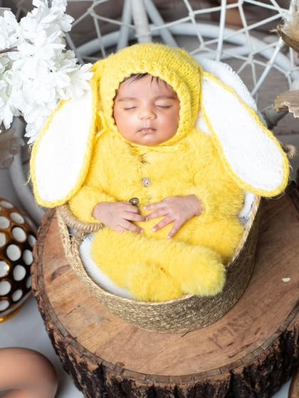 This sleeping bunny is nestled among flowers, creating a beautiful and serene portrait.