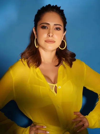Another close-up of the yellow Nidhi and Mahak outfit, showing the confident pose and matching hoop earrings.