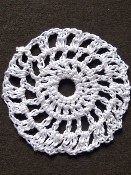 A small 3-inch crochet doily.