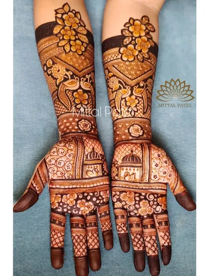 The full view of the floral engagement mehndi. The design combines bold flowers on the arms with traditional dome and bird motifs on the palms for a unique look.