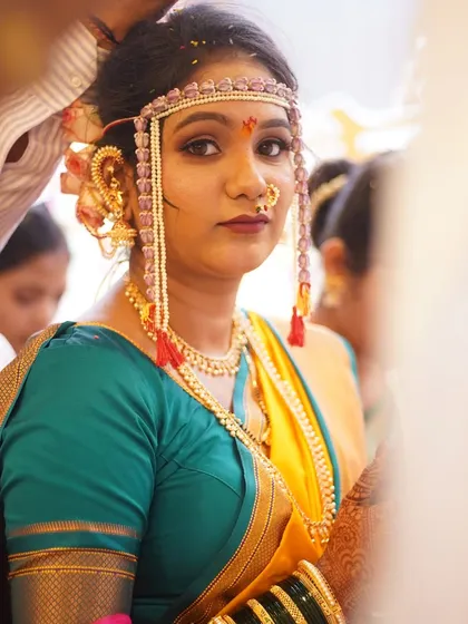 A beautiful portrait of the bride looking directly at the camera. Her makeup is flawless, with a focus on creating a radiant and even complexion.
