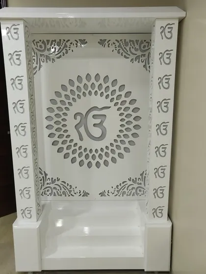 A frontal view of the 'Ek Onkar' mandir, showing the precision of the jali work on the pillars and back panel.