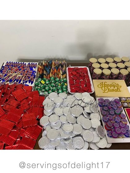 More Diwali madness! Trays filled with chocolate coins, rockets, and other festive shapes, all ready for packing into gift hampers.