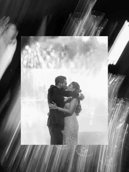 A stolen kiss amidst the chaos of the party. This artistic, blurry shot in black and white freezes a moment of pure romance on the dance floor.