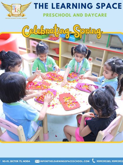 A table full of little hands creating art with flower petals. Group activities like this foster a sense of community and shared purpose among our young learners.