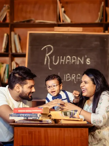 Learning is a family affair. I love capturing candid interactions, like this moment of shared laughter during a creative "little scholar" themed family photoshoot.