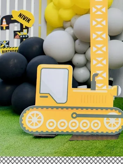 A close-up of the bulldozer prop, showcasing the detailed design and black and yellow color scheme.
