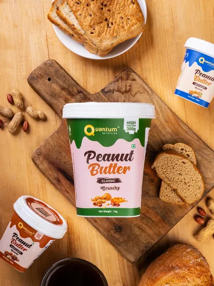 A flat lay of Quantum Nutrition's classic peanut butter, styled as part of a healthy breakfast. This lifestyle shot shows the product in a relatable, everyday context.