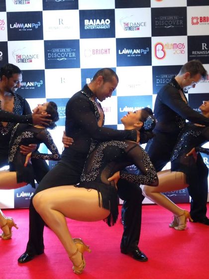 A group pose on the red carpet with our team. This showcases the synchronized and polished look of our performance troupe, ready for a major dance event.